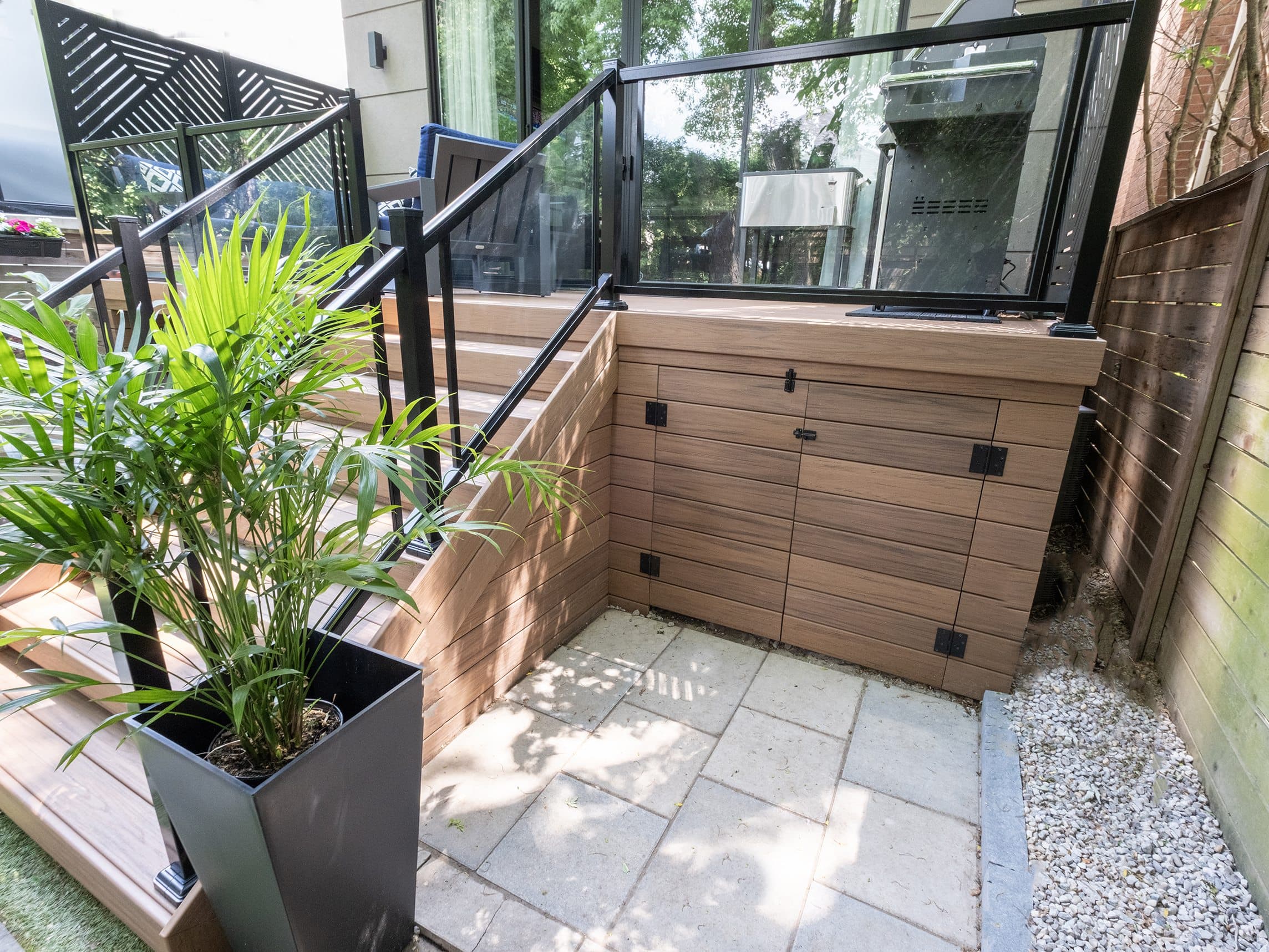 Built-in under-deck storage doors finished in matching composite skirting